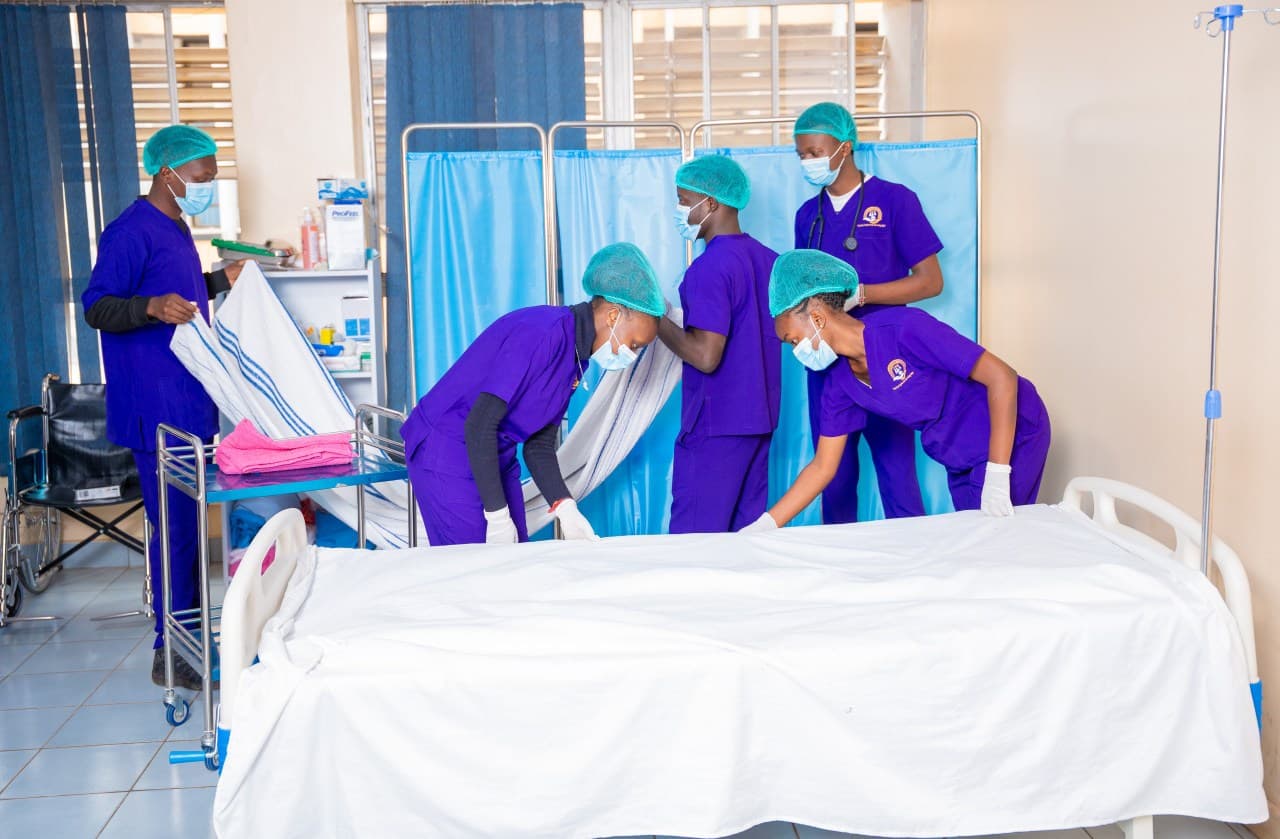 THM students practicing bed-making as a team